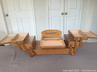 Fully open view of the wooden sewing box displaying multiple compartments and extendable wooden trays on both sides with metal supports.