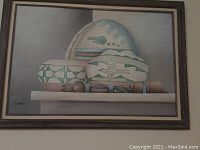 Full frontal photo of the framed Southwestern style painting showing pottery and wood objects.