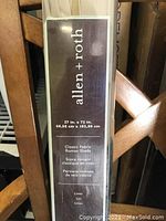 Close-up of Allen + Roth Classic Fabric Roman Shade label showing dimensions 27" x 72" and fabric type linen.