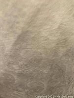 Close-up of textured surface of the table padding material showing fabric or foam texture.