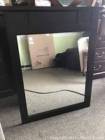 Front view of one wood framed mirror with espresso finish showing square shape and detailed frame top section.