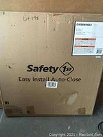 Outer cardboard box packaging of Safety 1st Easy Install Auto-Close Safety Gate showing brand and key product features