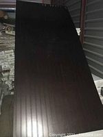 Single beadboard plywood sheet with a smooth, dark espresso finish and vertical grooves visible, measuring 42 x 92 inches approximately.