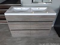 Front view of double bowl vanity showing composite top, two integrated sinks, four drawers, wood-grain finish