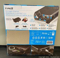 Box back showing detailed product features and accessories including storage case, USB ports, flashlight, jumper cable port, and button controls.