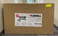 Sealed cardboard box labeled Lorell Deluxe Adjustable Sit to Stand Desk Riser