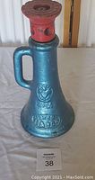 Photo of a vintage Vulcan brand railroad barn screw jack with a blue body and red top. Dimensions embossed on the item as 1 3/4 x 12 inches. The jack has a cast iron body with an integrated handle.