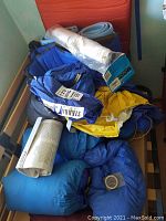 Overview of all backpacking and camping items piled on a bench