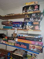 Shelf showing large-format games including Xtronaut, Last Night on Earth, Dead of Winter, Growing Hunger, Spaceopoly, Solarquest, Screaming Eagles, Axis & Allies
