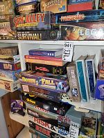Shelf view showing Spy Alley, Pandemic, Survival, Legacy and assorted games