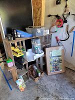 Seven short wooden shelves with assorted garden tools and accessories, including boxed greenhouse, yellow hose nozzle, gloves, seed packets, and various small containers.
