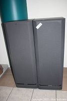 Front view of pair of rectangular Kenwood JL-464 speakers with fabric grilles and Kenwood logo on bottom bezel