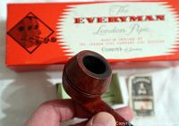 Pipe held in hand showing briar bowl with red polished finish.