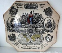 Full view of the octagonal commemorative plate with historical and imperial motifs, featuring Queen Victoria and export data from 1885.
