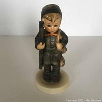 Front view of Hummel chimney sweep boy figurine showing detailed features and painted decoration.