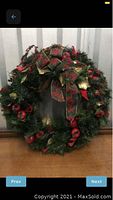 Full view of the decorated Christmas wreath showing overall design, size, and decorations.