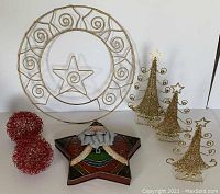 Full view of the lot showing the gold metal wreath card holder, red metal wire balls, tin Santa star, and three gold sparkly Christmas trees arranged on a white surface against white background.