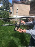 Front view showing twin wings and three-blade propeller