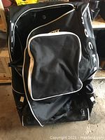 Overall front view of the Grit black hockey bag showing front pocket and large main compartment