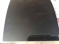 Top view of Sony PlayStation 3 Slim console showing PS3 logo and matte black finish.