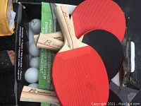 Wooden Eastpoint table tennis paddles with red and black rubber surfaces and white plastic ping pong balls in packaging.