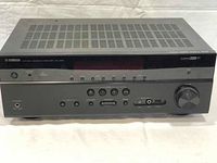 Front view of Yamaha RX-V475 AV receiver showing front panel display, control buttons and volume knob.