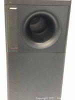 Front view of black rectangular Bose woofer with port.