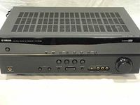 Front view of Yamaha Natural Sound AV Receiver HTR-3063 showing control buttons, headphone jack, input ports and volume dial on black panel.