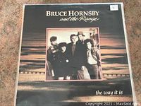 Single LP cover of Bruce Hornsby and The Range - The Way It Is, showing a group portrait on dark background.