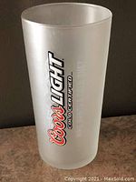 Front view of frosted Coors Light Cold Certified beer glass with logo text visible on the side.