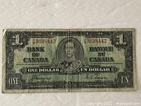 Front view of the 1937 Canadian one dollar note featuring King George VI, showing the serial number and signatures.