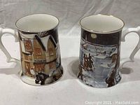 Both vintage tankards side by side showing full design with winter scenes, snow, and Carling O'Keefe signage.