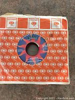 Close-up of Jefferson Starship 'Hyperdrive' 45 RPM vinyl record in orange Columbia Records paper sleeve, showing label detail and sleeve condition.