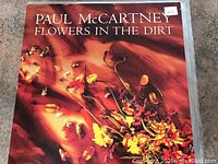 Close-up photo of Paul McCartney 'Flowers in the Dirt' LP cover showing album artwork and condition.