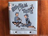 Front view of the light blue Rhythm Tote carrying case with cartoon illustration and musical notes.