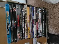 Photo of 13 DVD cases showing a variety of movie and TV series titles, with colorful spines and artwork.