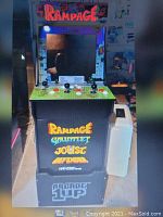 Front view of full-size arcade cabinet featuring Rampage and other classic arcade games with multiple controls.