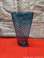 Front view of a tall conic oval-shaped spiral art glass vase showing clear and teal spiral bands with good lighting.