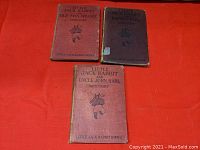 Three hardcover vintage Little Jack Rabbit books arranged on an orange surface, showing front covers of each book with titles and author David Cory.