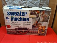 Original retail box for Incredible Sweater Machine with printed images of sweaters and instructions on front. Box is closed and shows some wear.