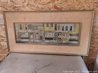 Full view of mid-century storefront painting by Margaret Layton, framed behind glass with beige mat.