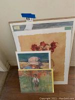 View of four paintings grouped together showing floral pastel and watercolors of children