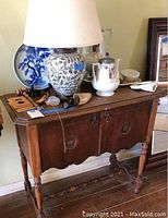 Front left angle view showing decorative details, turned legs and stretcher base, scratches on wood surface.