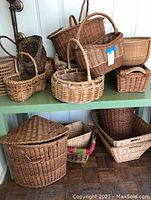 Multiple woven baskets displayed on two shelves including round, rectangular, and square shapes with some showing wear and missing weaves.