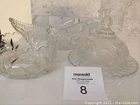 Full set view showing two oval bowls, a round bowl, a butter dish with lid, and a creamer on a marble surface.