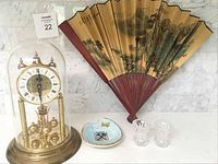 Photo showing the full lot: Haller clock under glass dome, two crystal candlesticks, Asian folding fan, Hayange France plate
