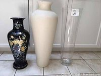 Full view of all three tall vases side by side on floor
