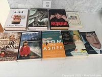 Nine biography books arranged in two rows showcasing titles and cover art for identification.