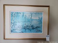 Full frontal photo of framed print by Keirstead, showing birch trees by water in blue tones.