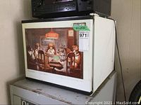 Full view of the Danby reversible mini fridge showing the metal dog sign taped to the front door.